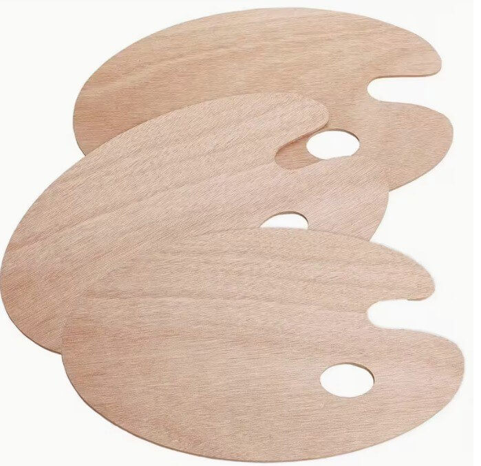 Thee wooden artist palettes on a white background
